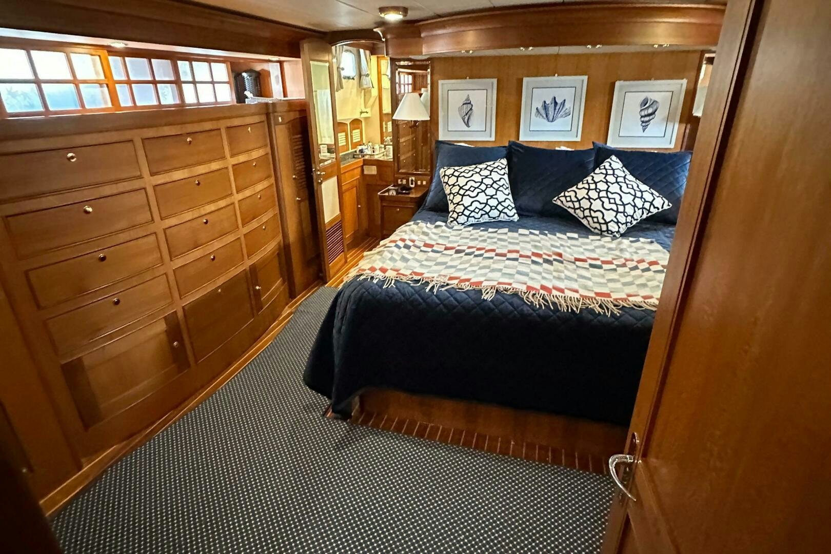 a bedroom with a bed and dresser aboard MISS STEPHANIE  Yacht for Sale