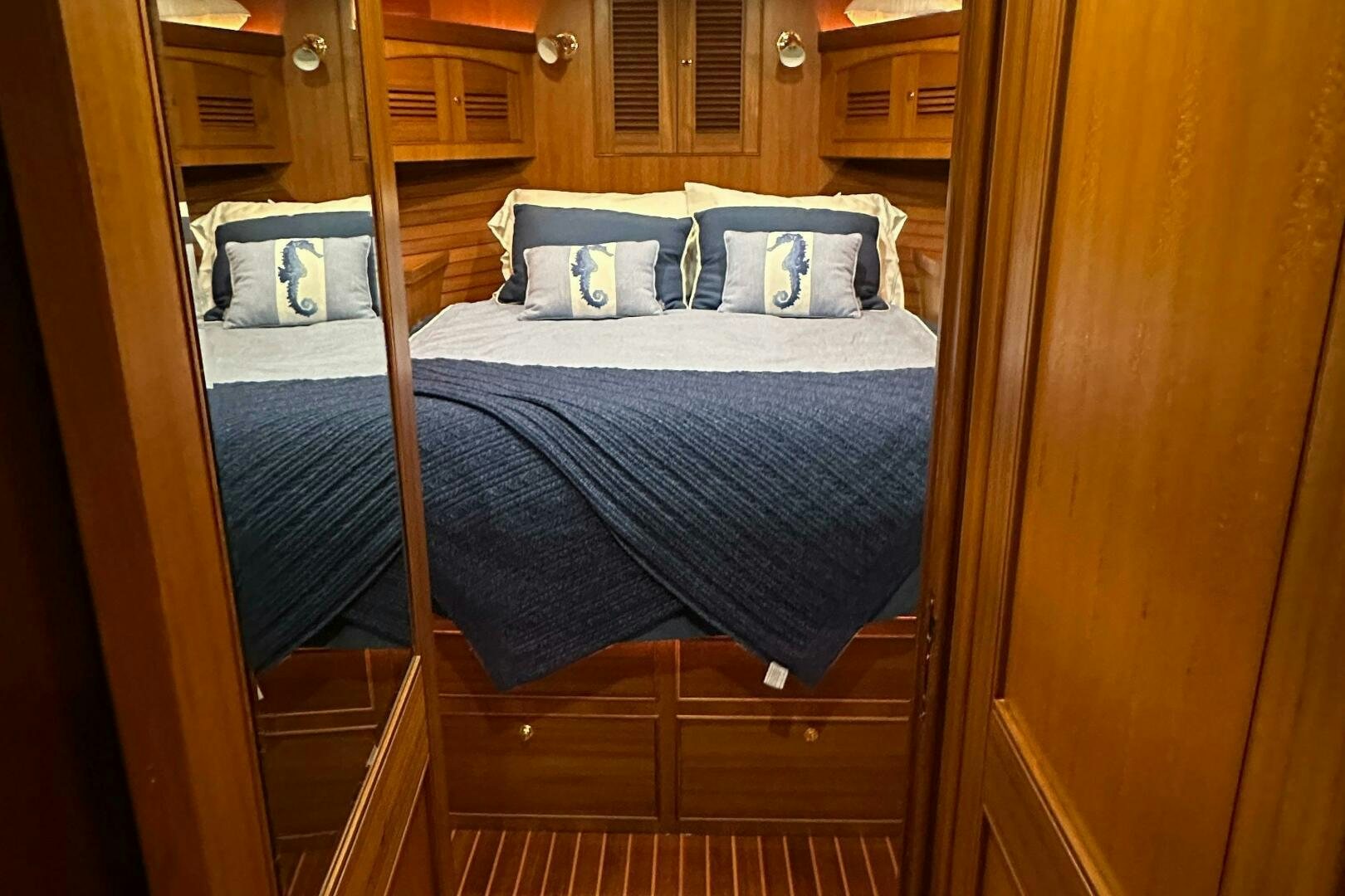 a bed with a blue sheet aboard MISS STEPHANIE  Yacht for Sale