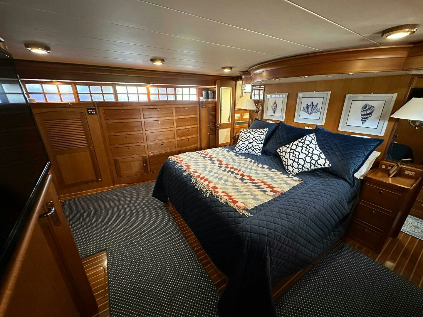 a bedroom with a bed and a wood cabinet aboard MISS STEPHANIE  Yacht for Sale