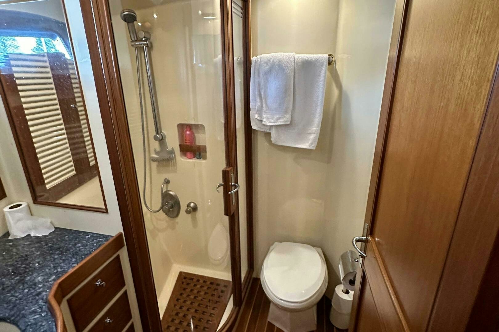 a bathroom with a glass shower aboard MISS STEPHANIE  Yacht for Sale
