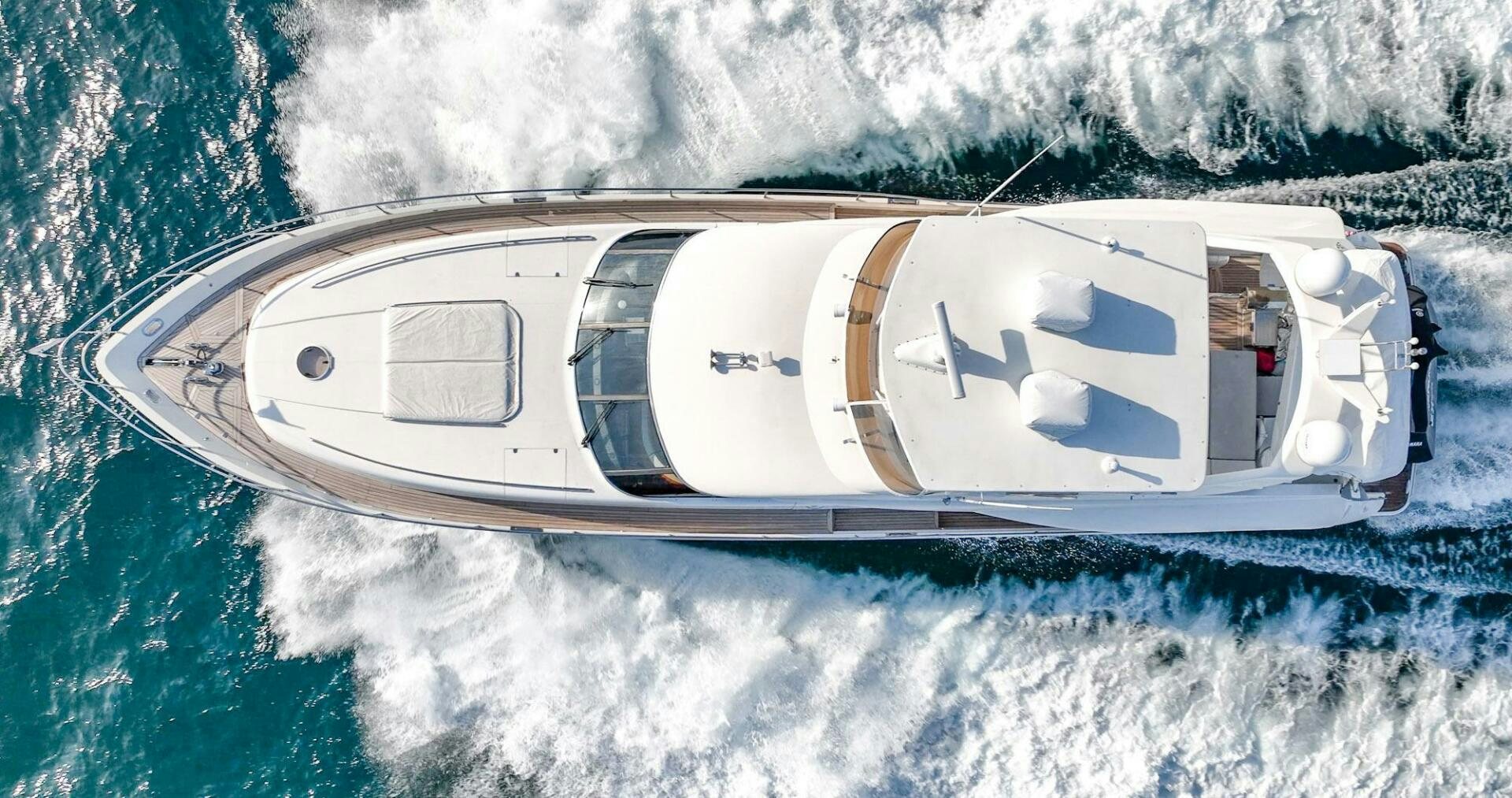 a white helicopter above a body of water aboard HALF MINE Yacht for Sale