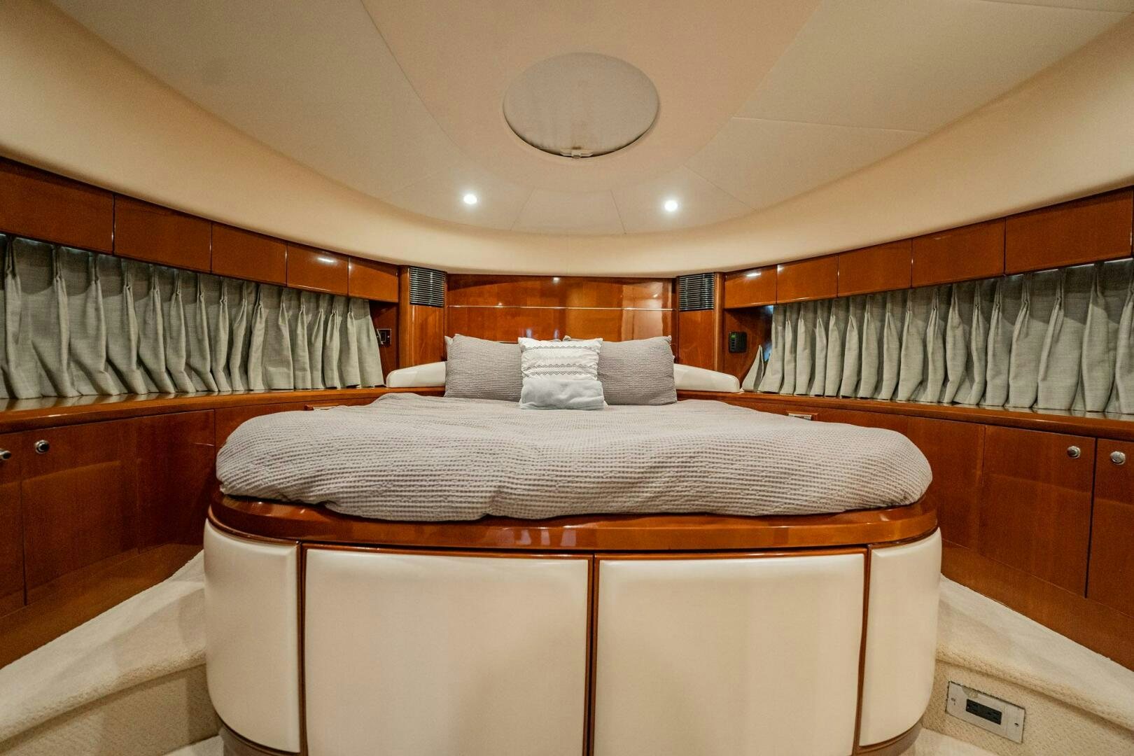 a bed with a white cover aboard HALF MINE Yacht for Sale