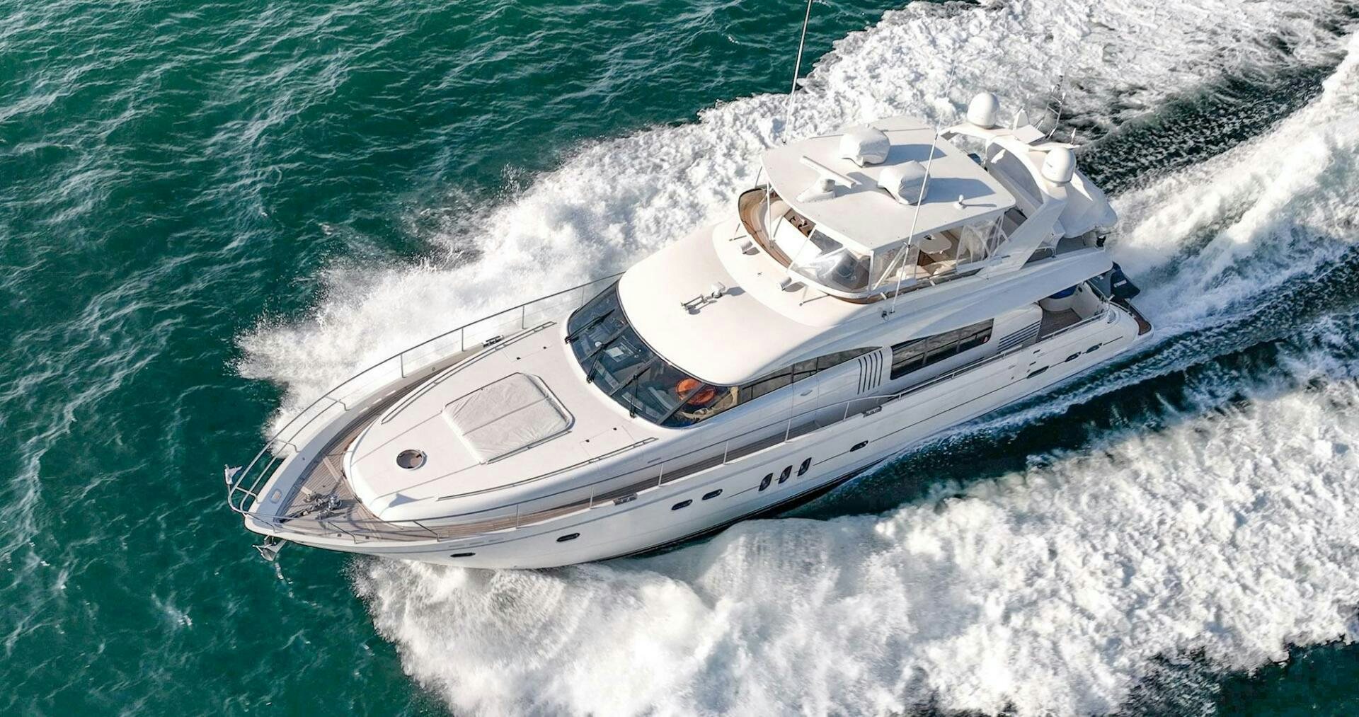 a white boat on the water aboard HALF MINE Yacht for Sale