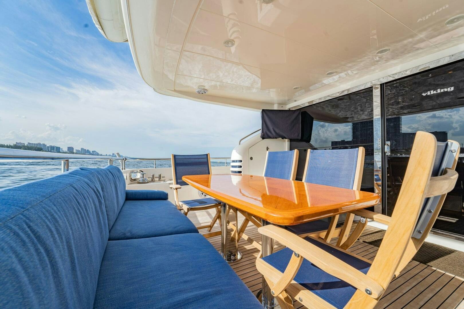 a boat with a table and chairs aboard HALF MINE Yacht for Sale