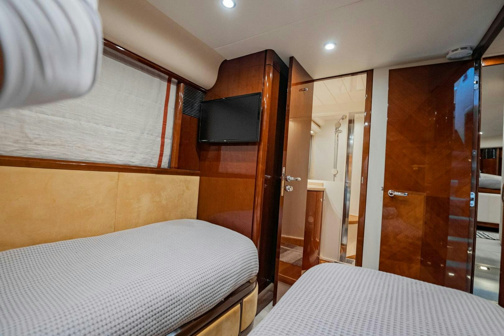 a room with a bed and a television aboard HALF MINE Yacht for Sale