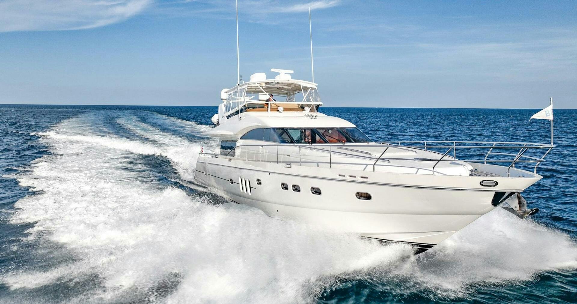 a white boat on the water aboard HALF MINE Yacht for Sale