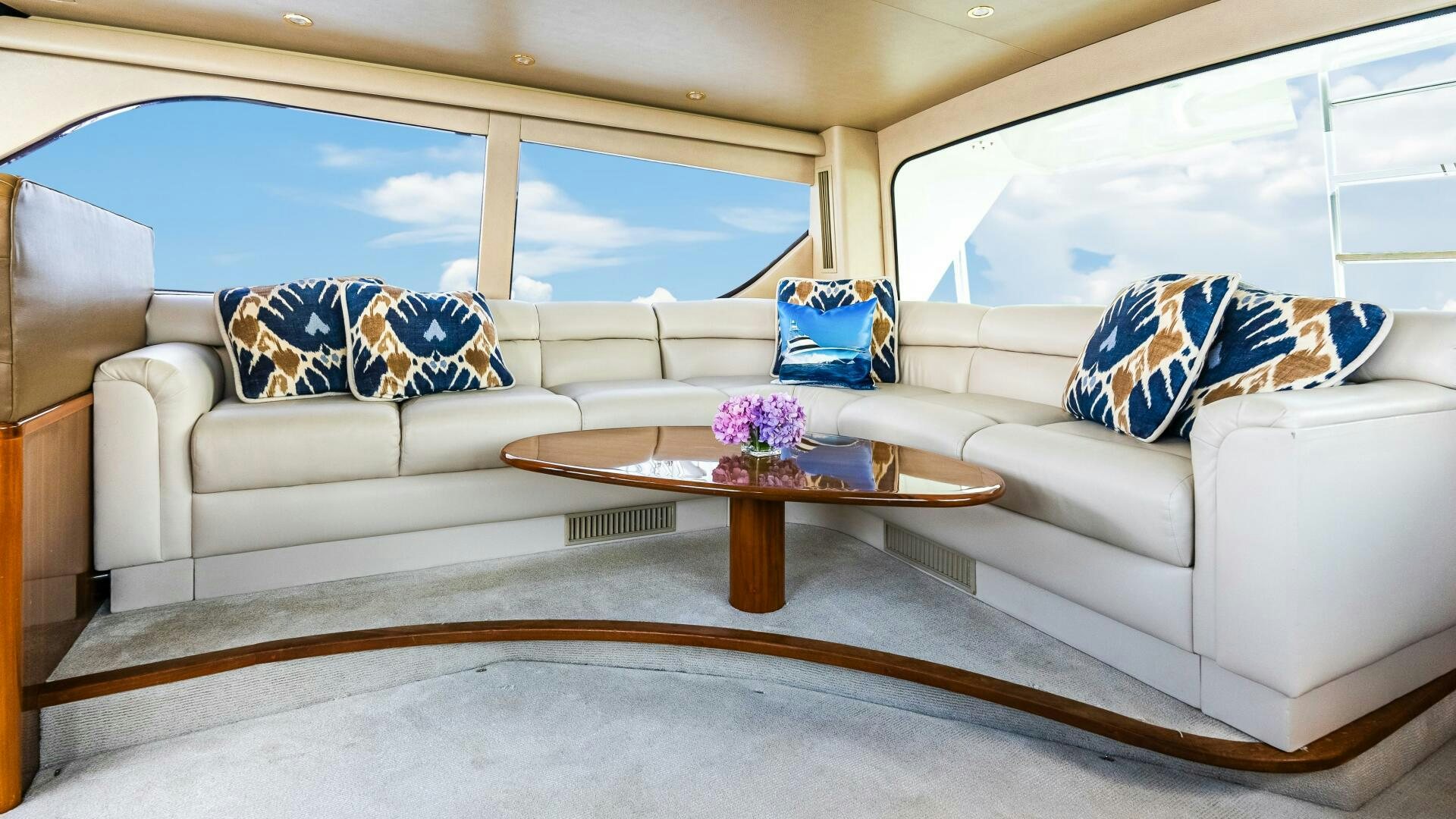 a living room with a couch and a coffee table aboard BLUE EYES Yacht for Sale