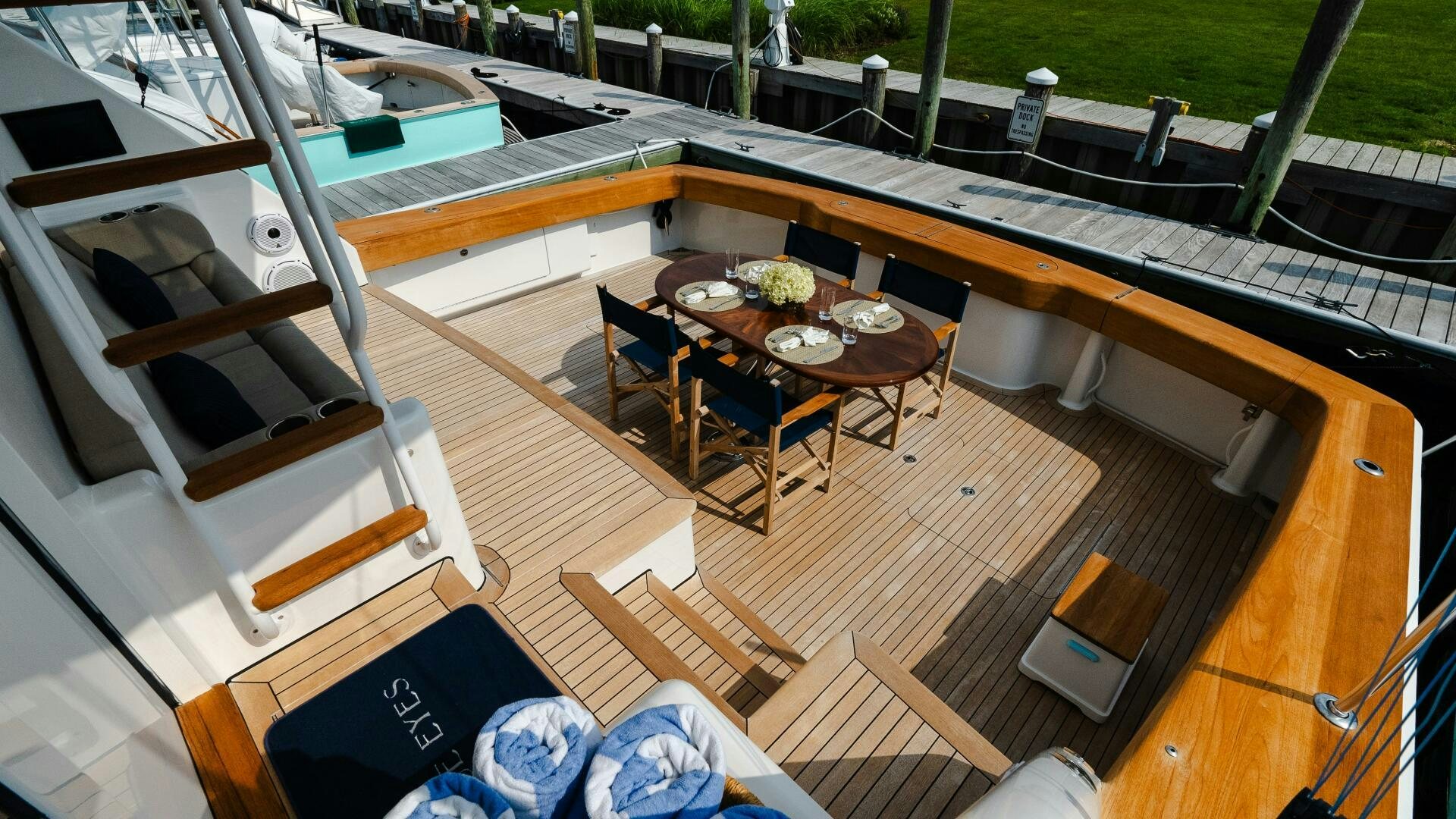 a deck with a table and chairs aboard BLUE EYES Yacht for Sale