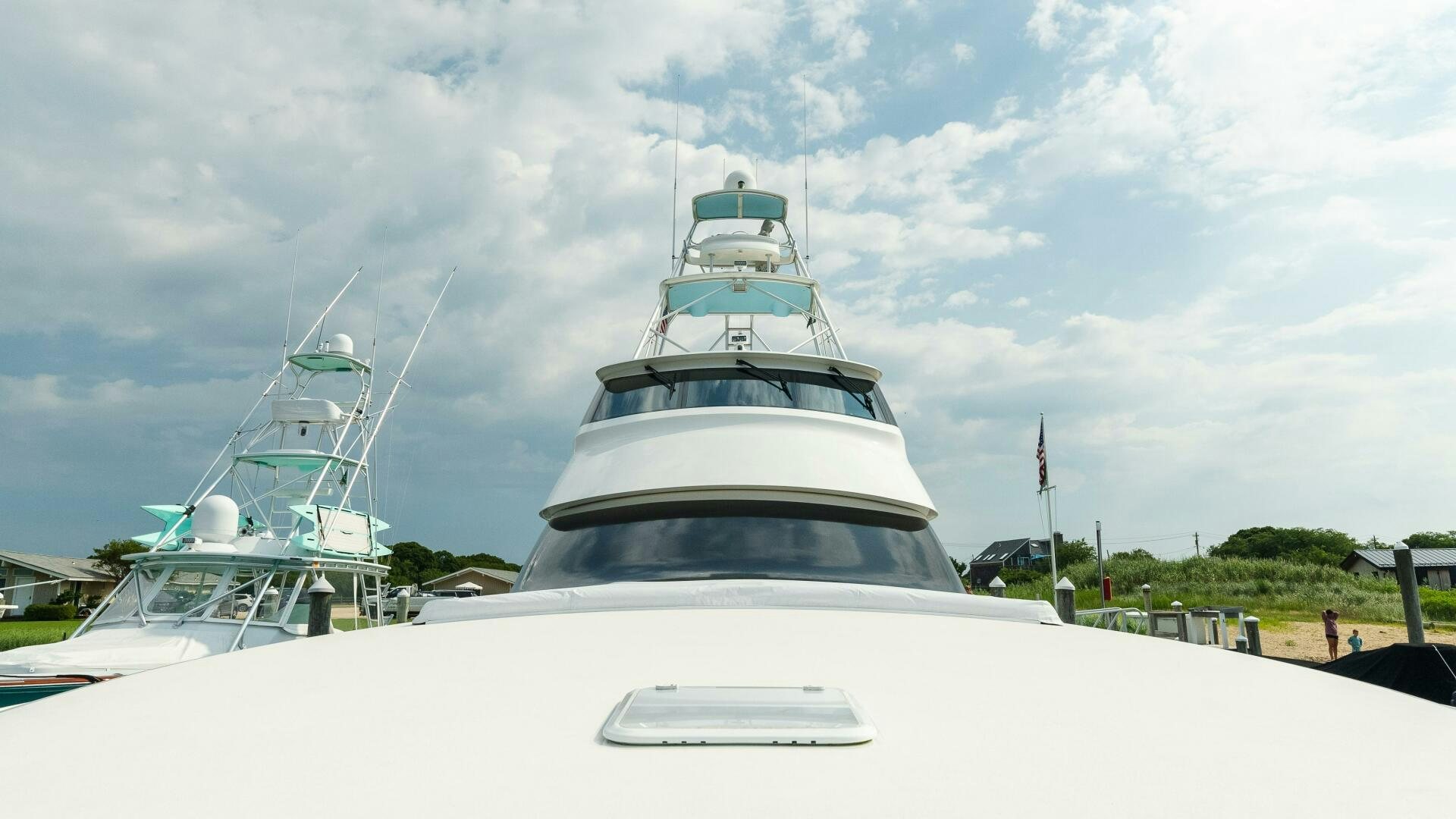a white boat with a blue roof aboard BLUE EYES Yacht for Sale