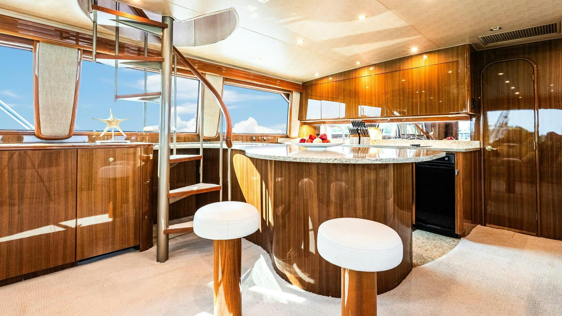 a kitchen with a ladder and stools aboard BLUE EYES Yacht for Sale