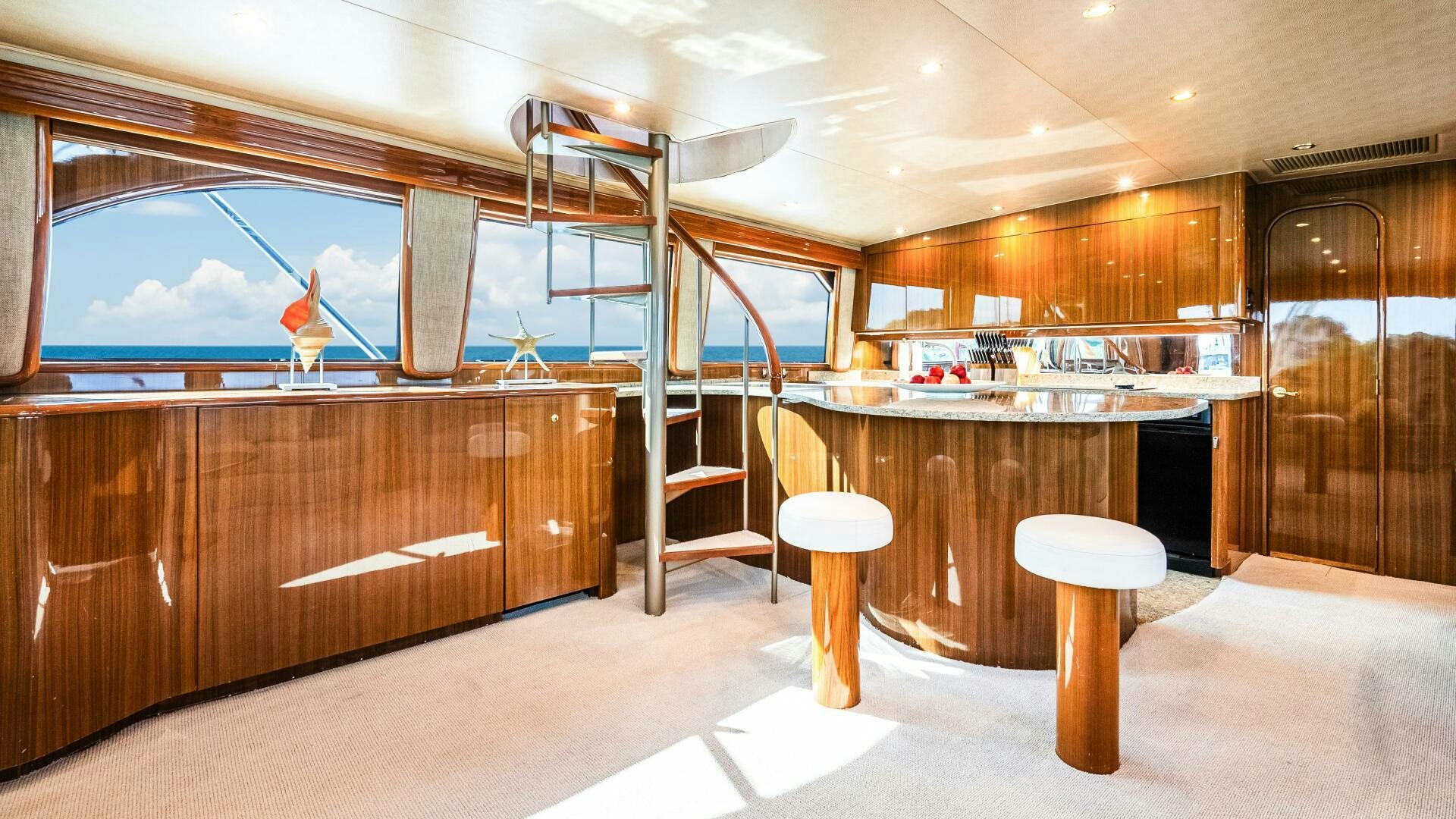 a room with a table and stools and a ladder aboard BLUE EYES Yacht for Sale