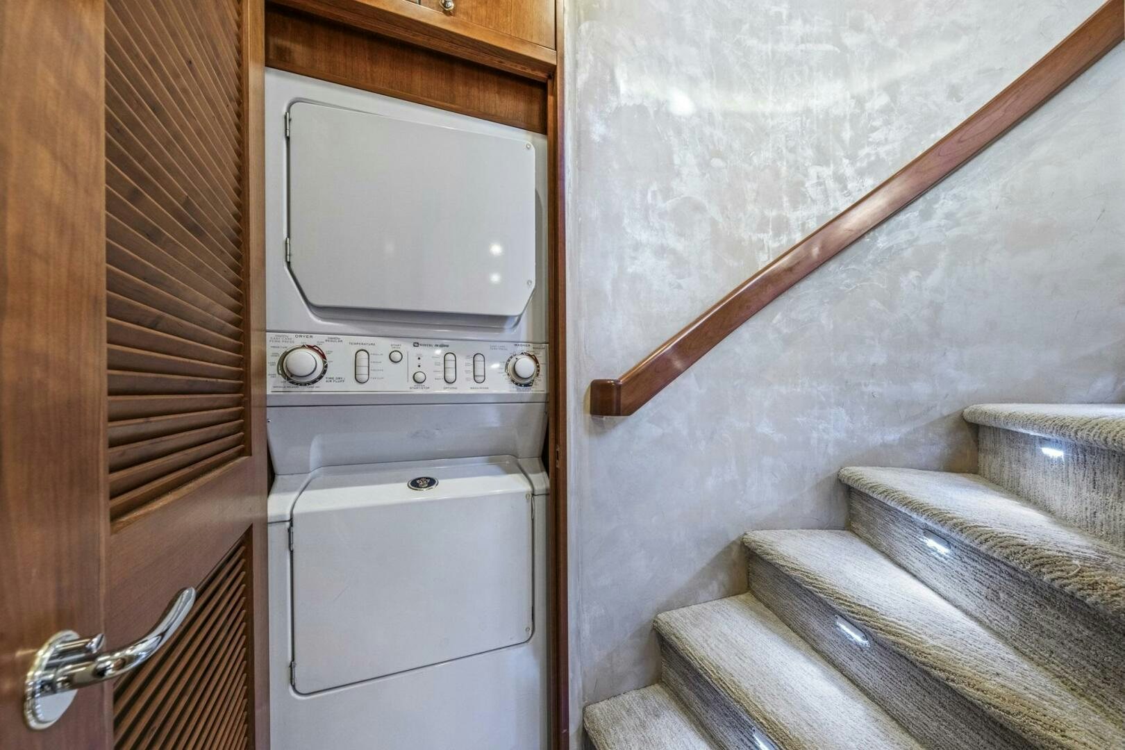 a white microwave oven on a wooden door aboard LIFE'S A JOURNEY Yacht for Sale