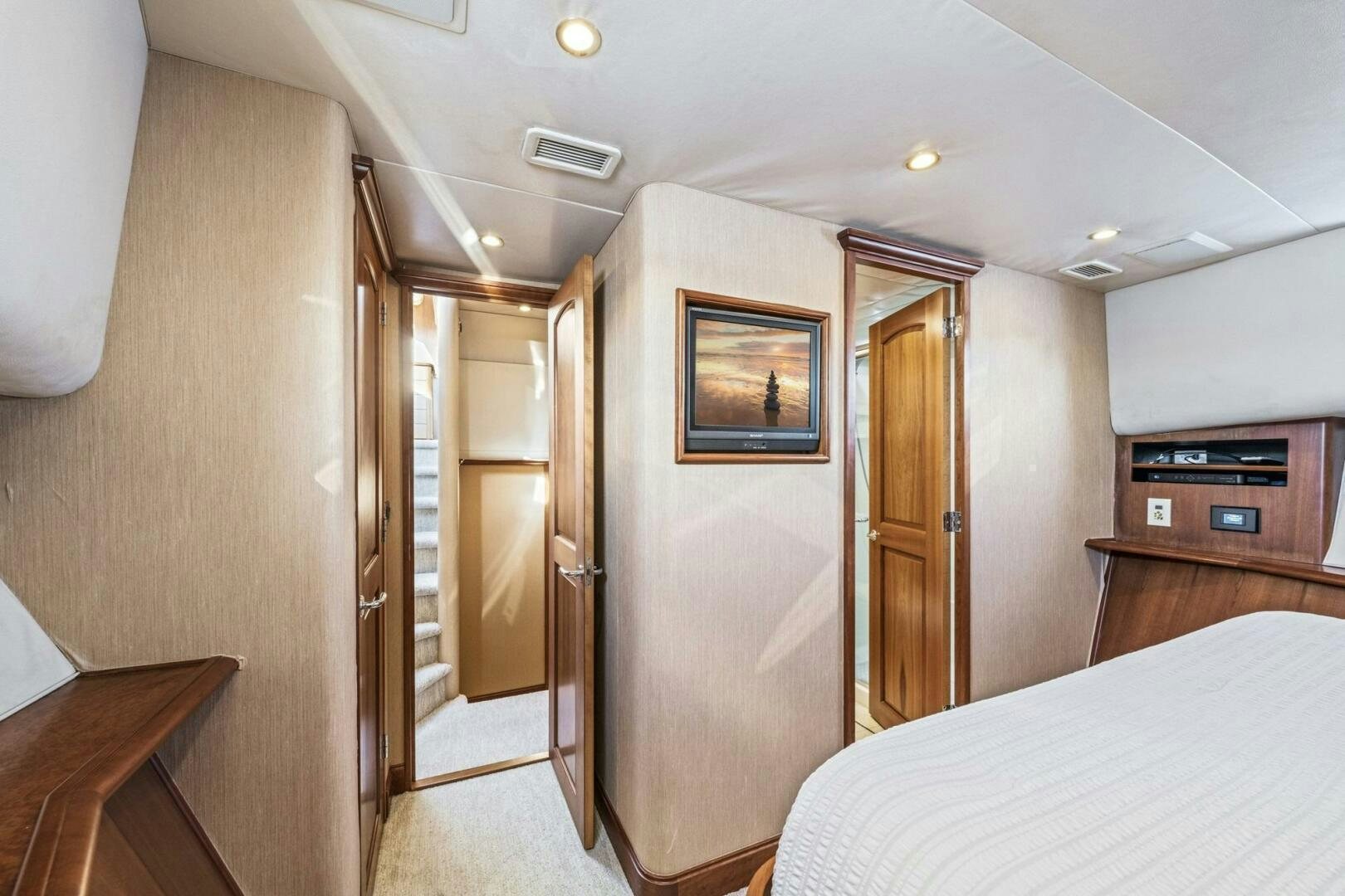 a hotel room with a bed and a door aboard LIFE'S A JOURNEY Yacht for Sale