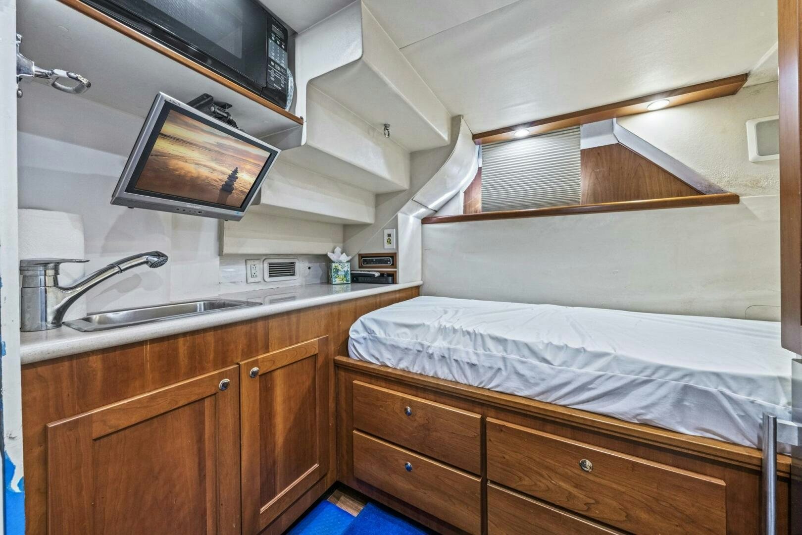 a bedroom with a bed and a television aboard LIFE'S A JOURNEY Yacht for Sale