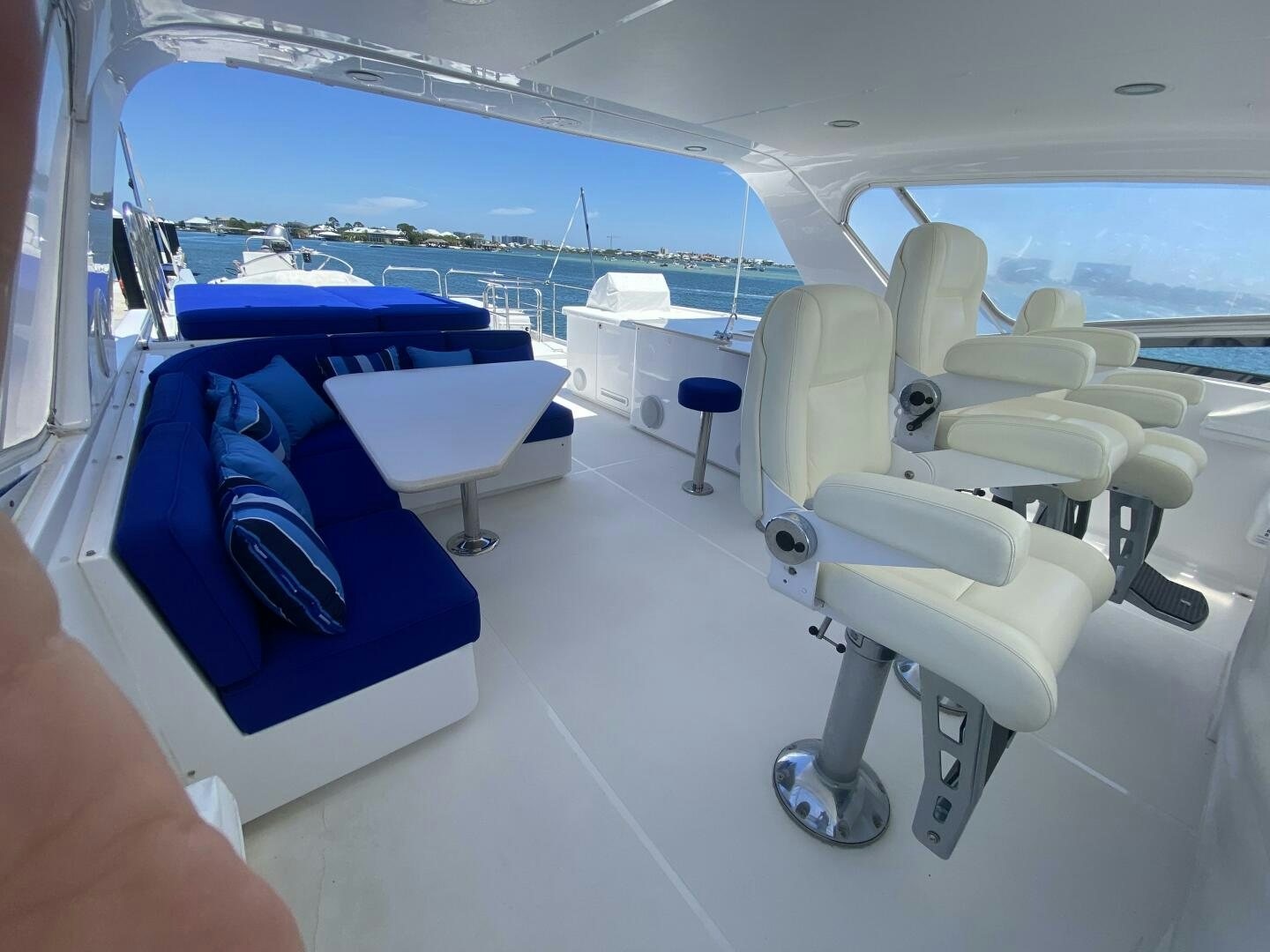 a room with a blue bed and white chairs aboard LIFE'S A JOURNEY Yacht for Sale