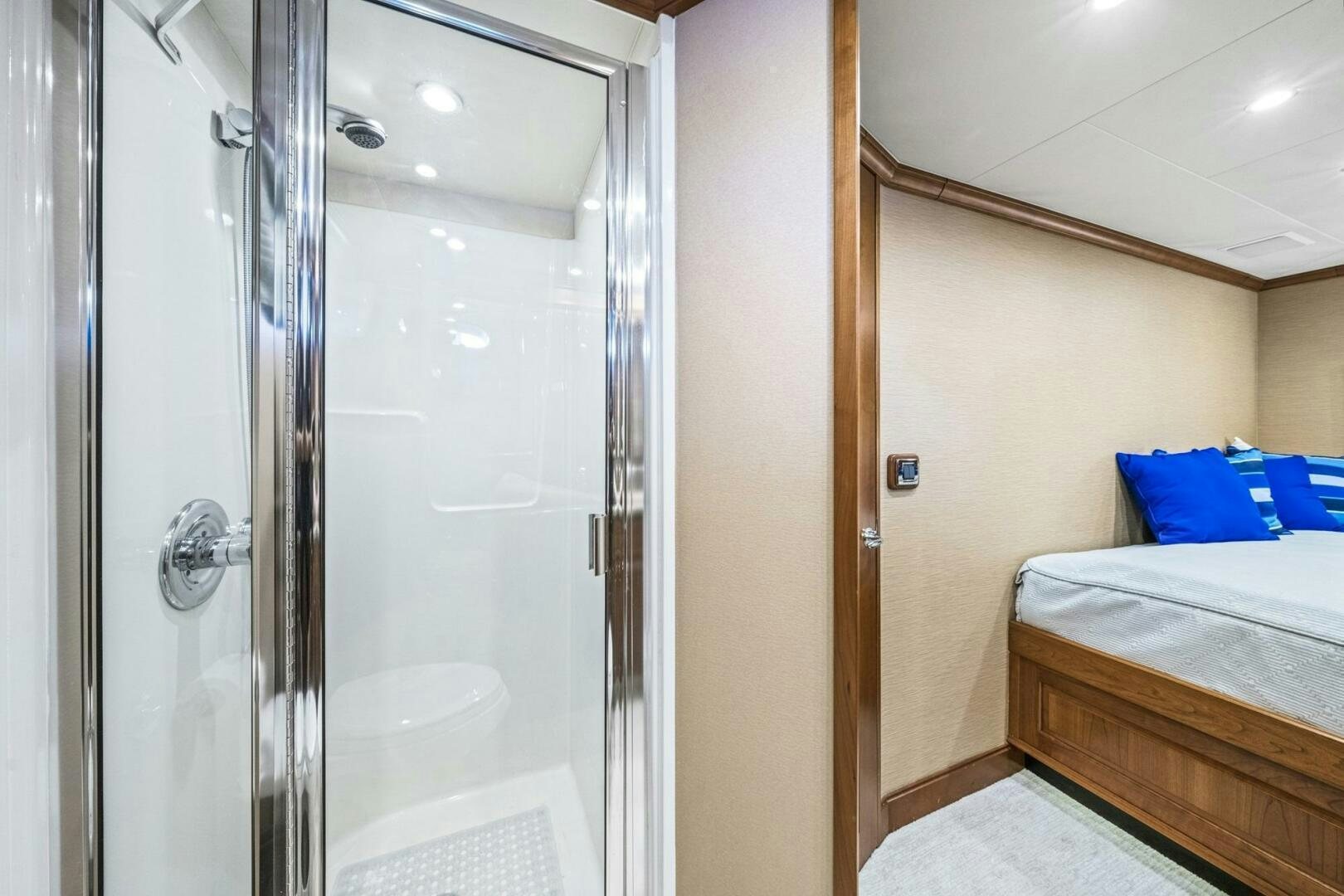 a bedroom with a glass shower aboard LIFE'S A JOURNEY Yacht for Sale