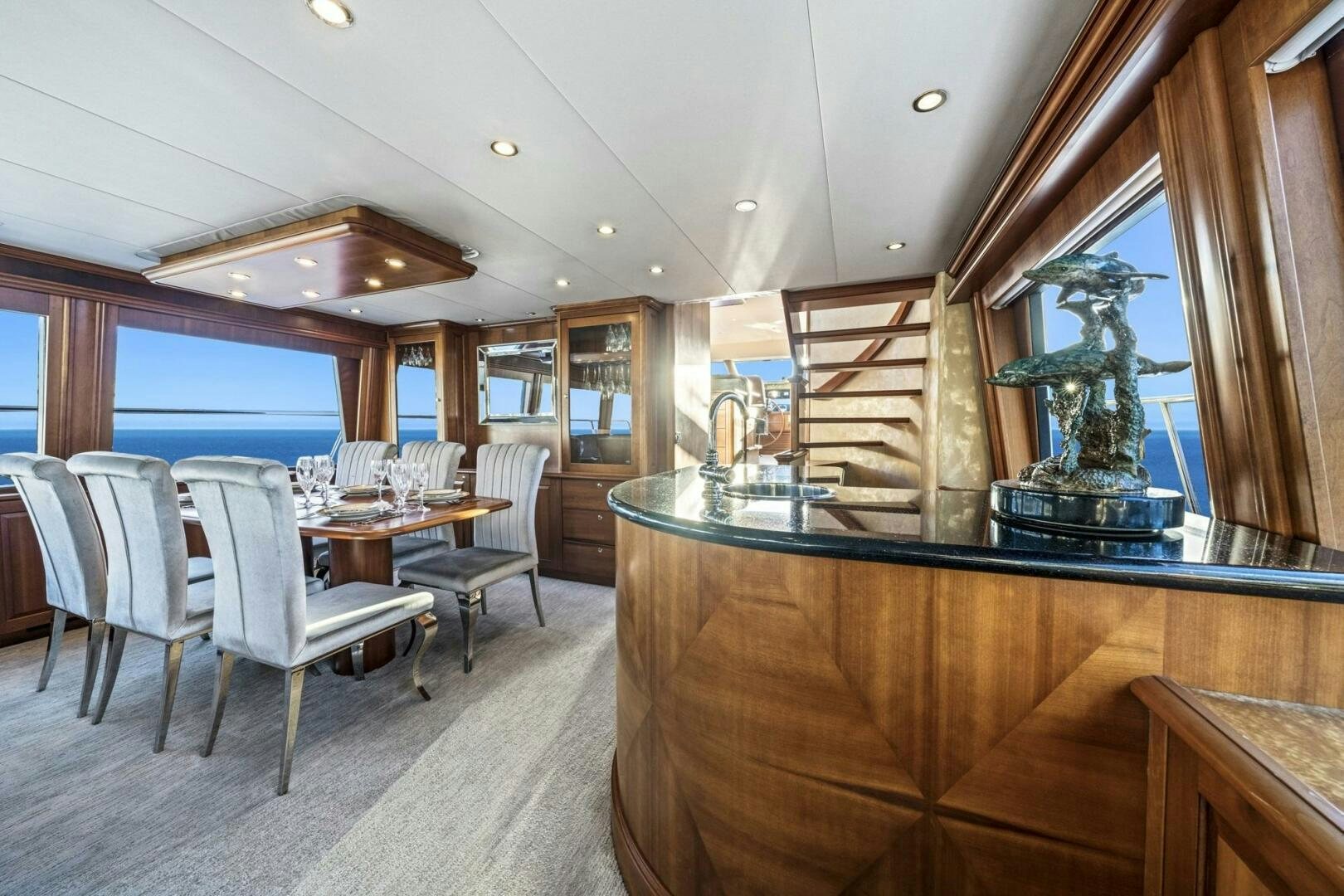 a large dining room with a wood table and chairs aboard LIFE'S A JOURNEY Yacht for Sale