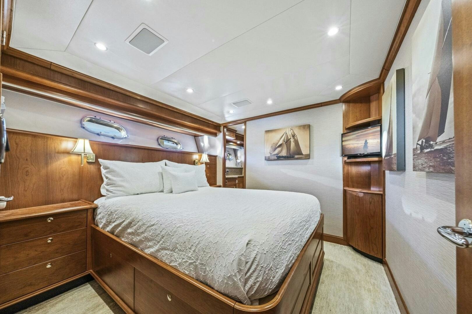 a bedroom with a bed and a dresser aboard LIFE'S A JOURNEY Yacht for Sale