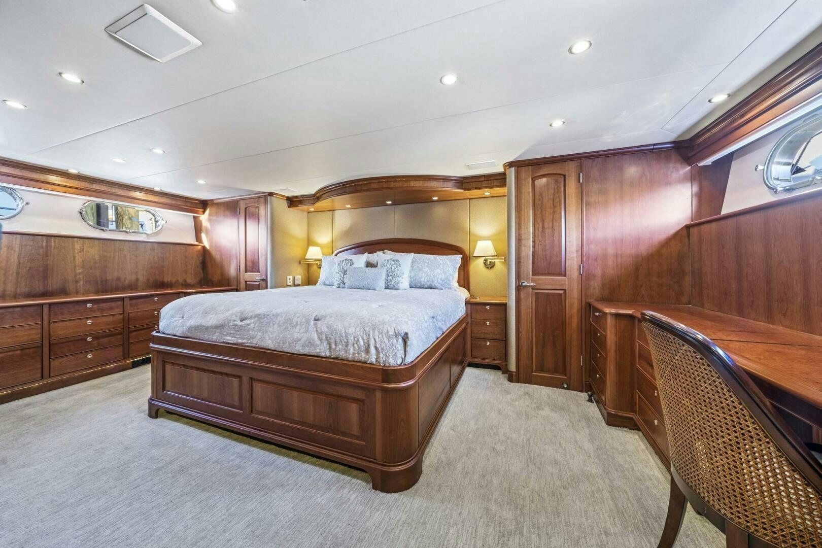a bedroom with a bed and a chair aboard LIFE'S A JOURNEY Yacht for Sale