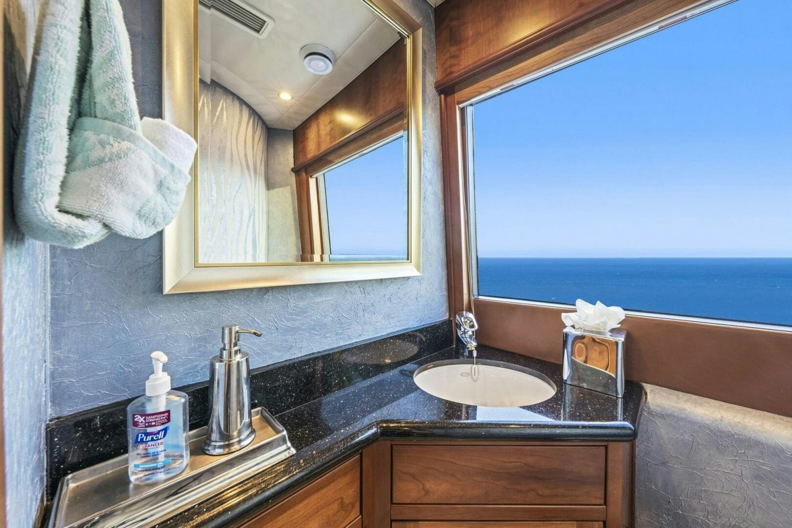 a bathroom with a sink and a large mirror aboard LIFE'S A JOURNEY Yacht for Sale