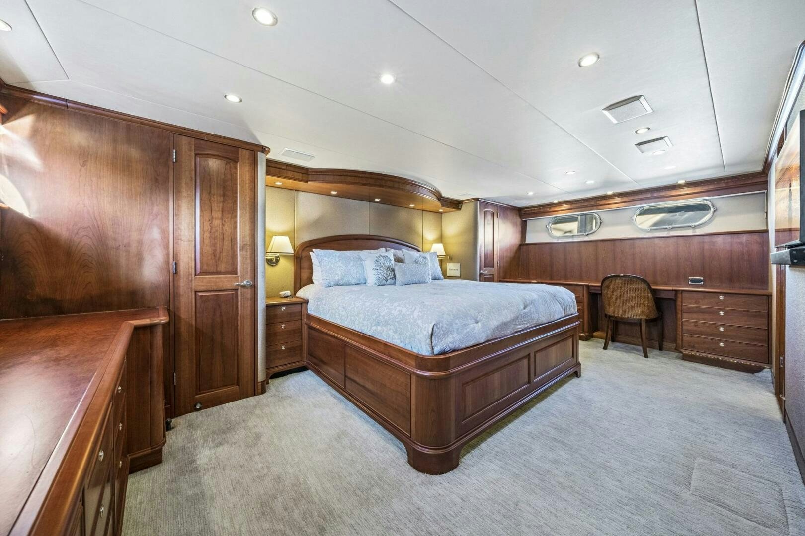a bedroom with a bed and a chair aboard LIFE'S A JOURNEY Yacht for Sale