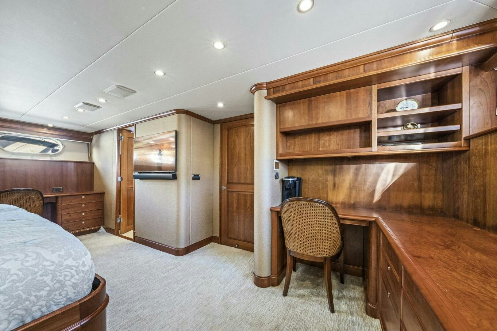 a bedroom with a bed and desk aboard LIFE'S A JOURNEY Yacht for Sale