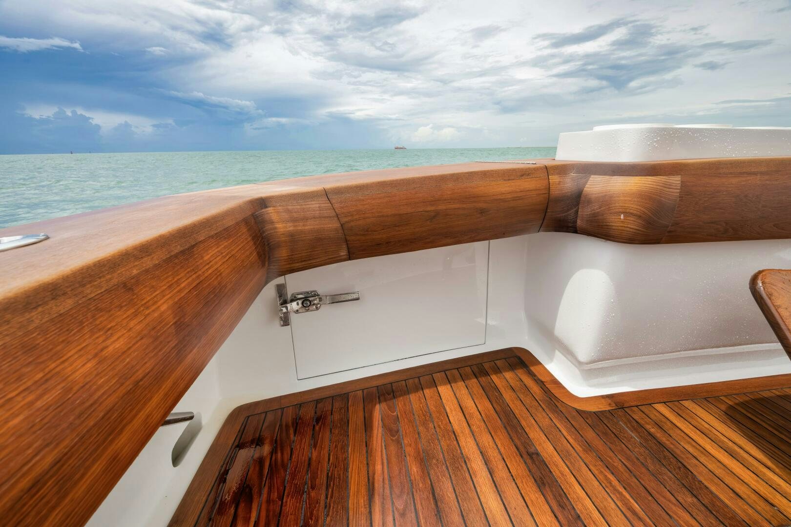 a wooden deck with a large body of water in the background aboard LET  RIDE Yacht for Sale