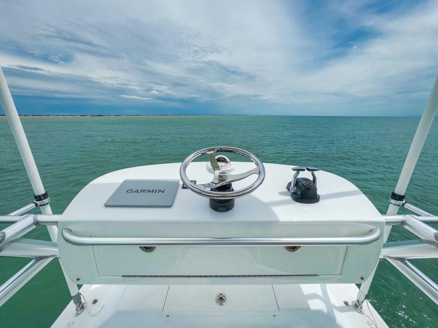 a boat with a steering wheel and a ship in the water aboard LET  RIDE Yacht for Sale
