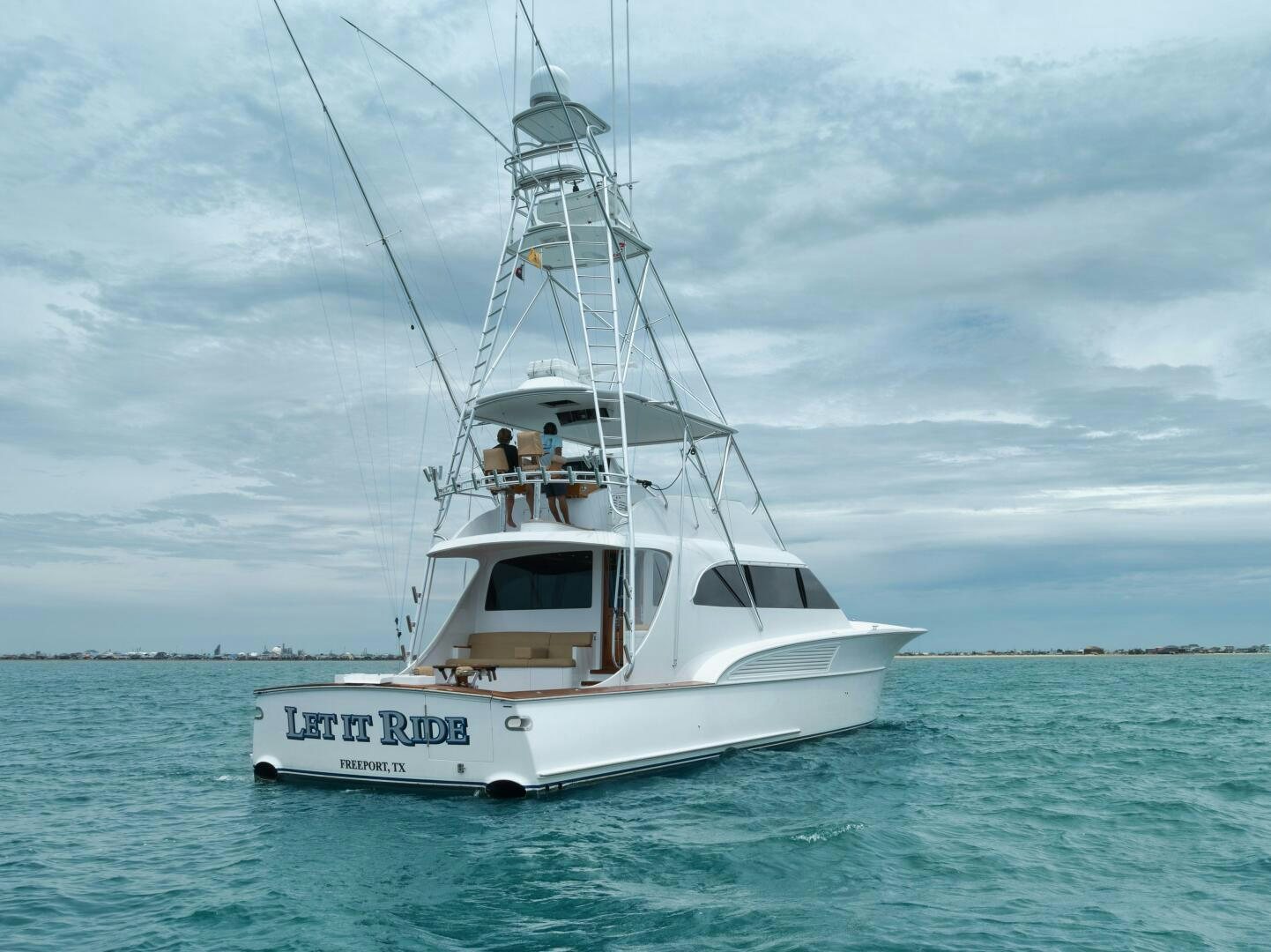 a white boat in the water aboard LET  RIDE Yacht for Sale