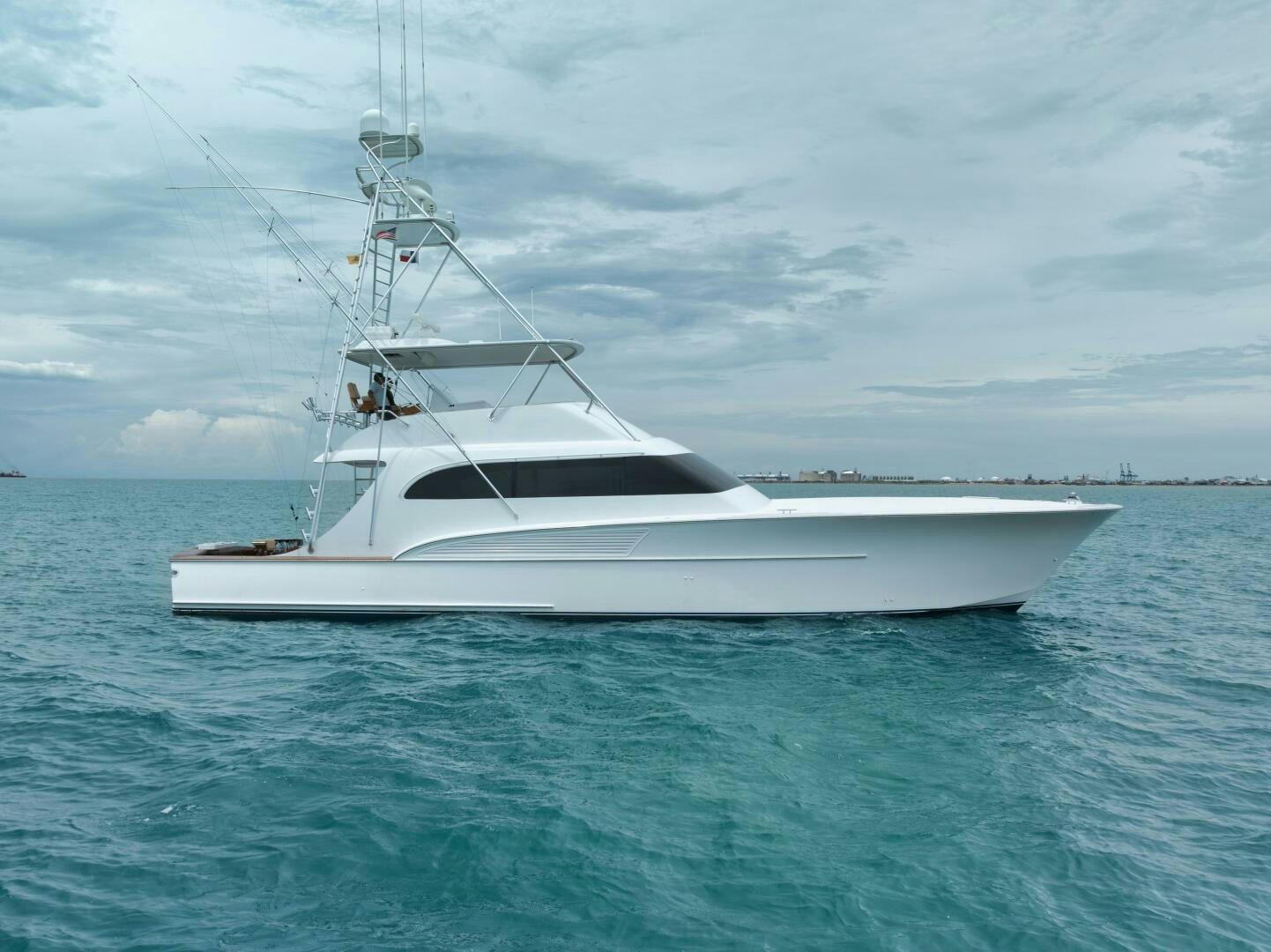 a white boat in the water aboard LET  RIDE Yacht for Sale