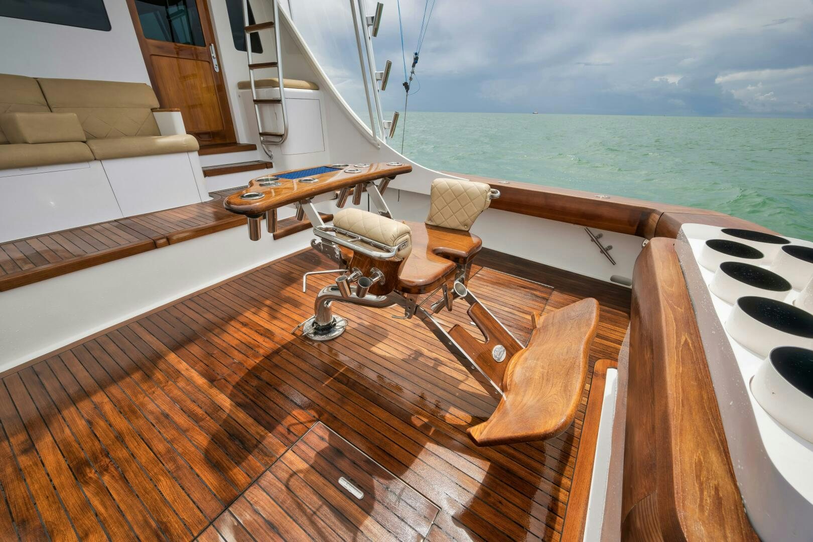 a deck with a table and chairs on it aboard LET  RIDE Yacht for Sale