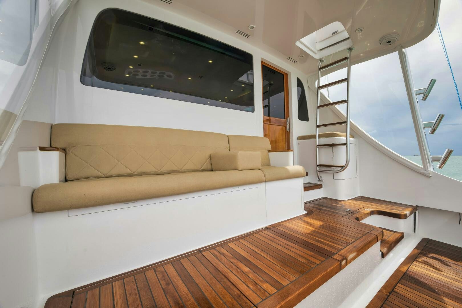 a white couch in a room aboard LET  RIDE Yacht for Sale