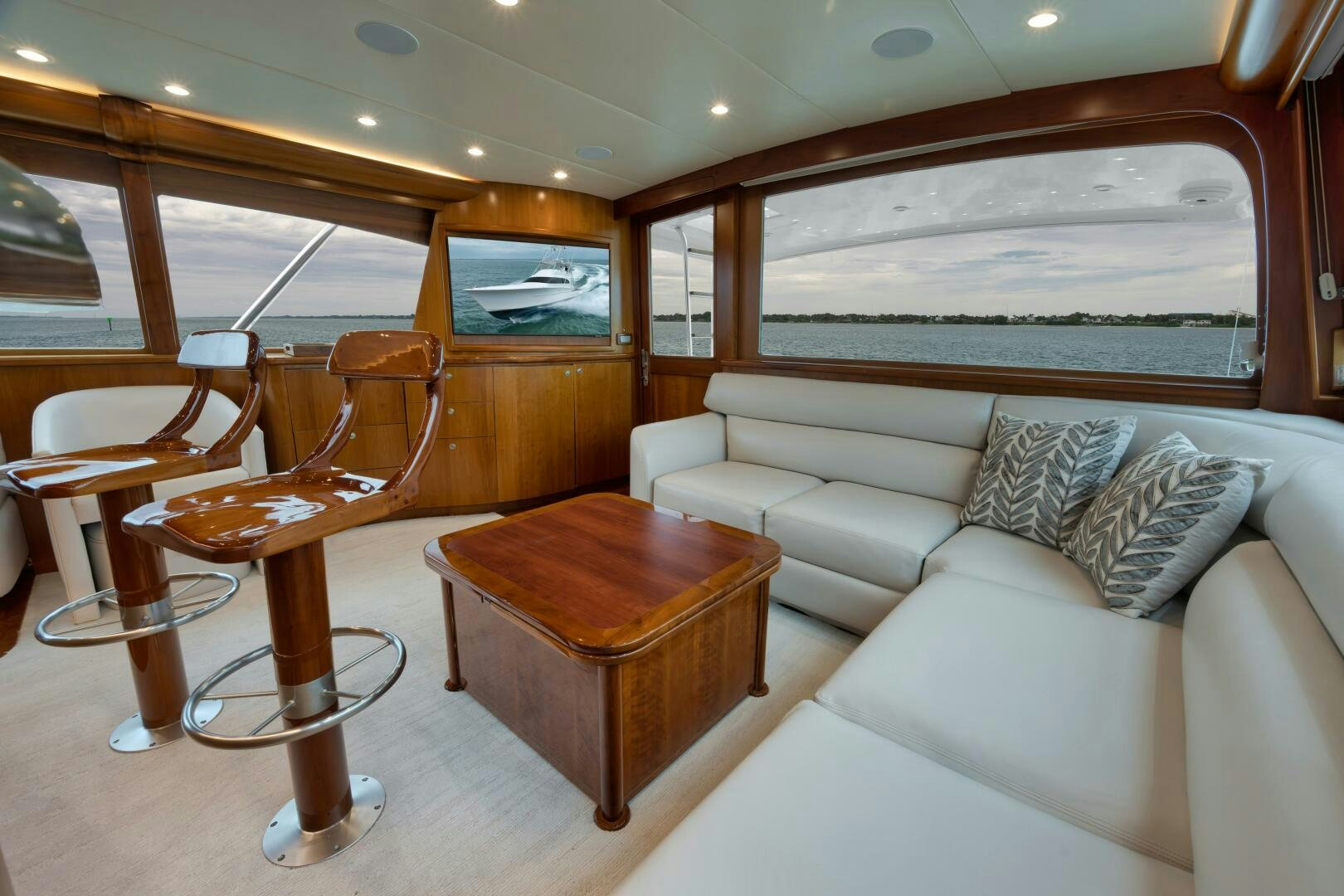 a living room with a couch and a coffee table aboard LET  RIDE Yacht for Sale