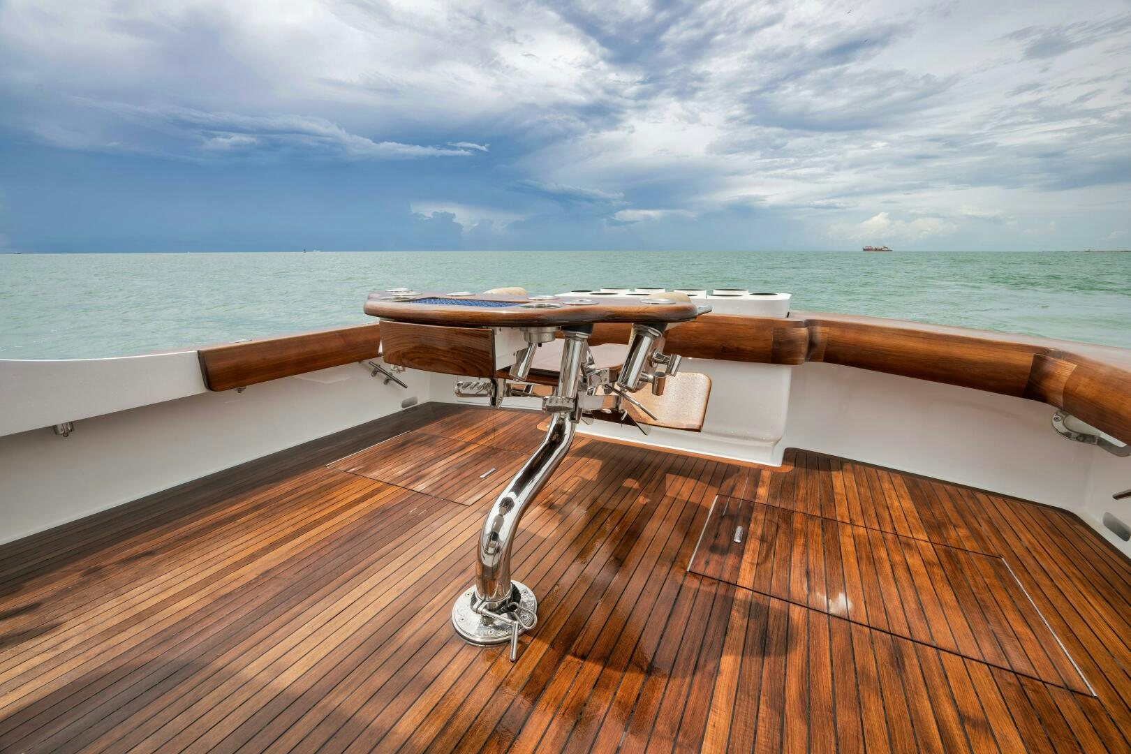 a wooden deck overlooking a body of water aboard LET  RIDE Yacht for Sale