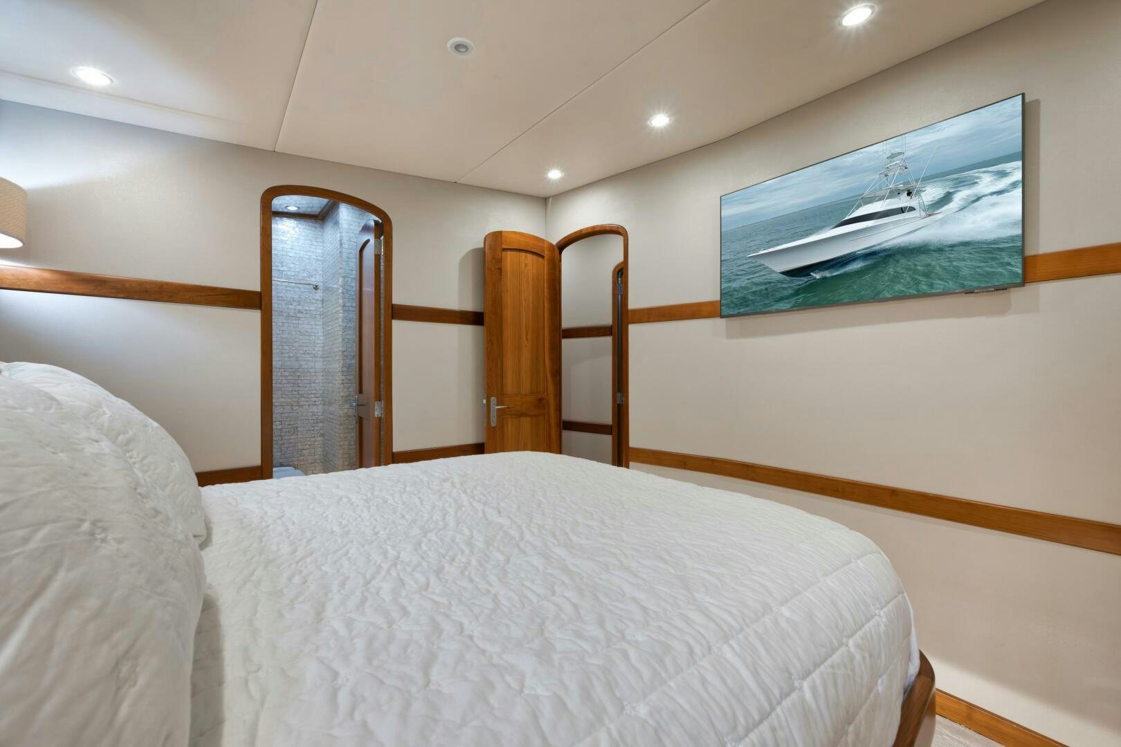 a bed with a mirror above it aboard LET  RIDE Yacht for Sale
