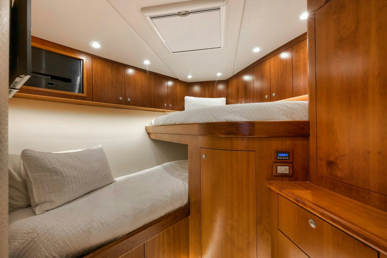 a bedroom with a bed and a microwave aboard LET  RIDE Yacht for Sale