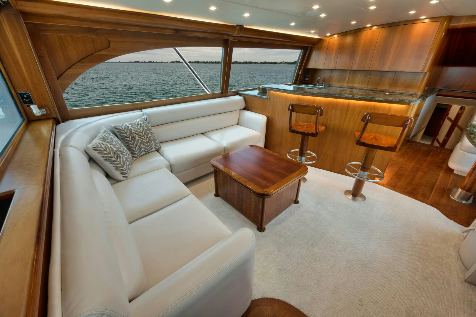 a living room with a couch and a table aboard LET  RIDE Yacht for Sale