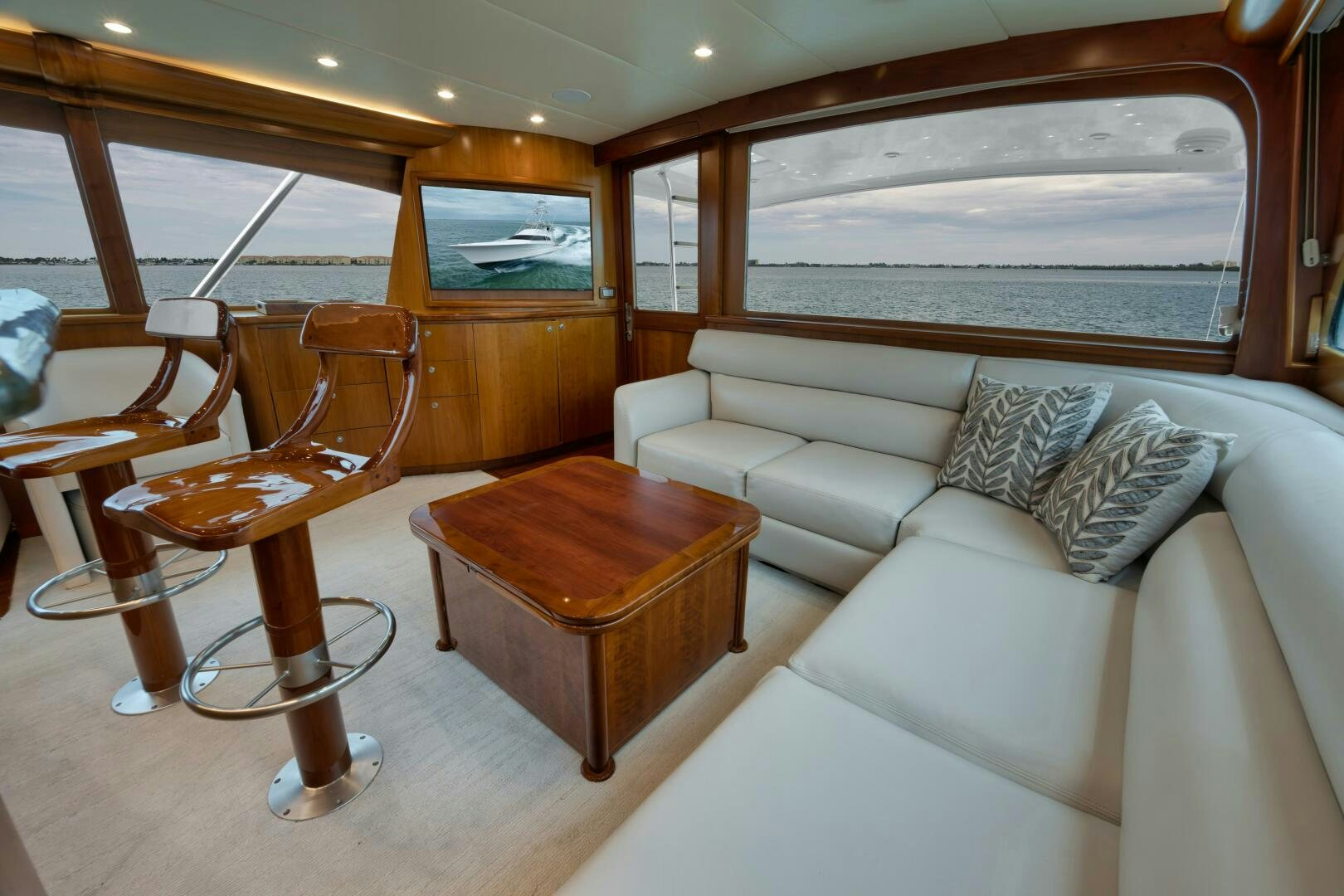 a living room with a couch and a coffee table aboard LET  RIDE Yacht for Sale