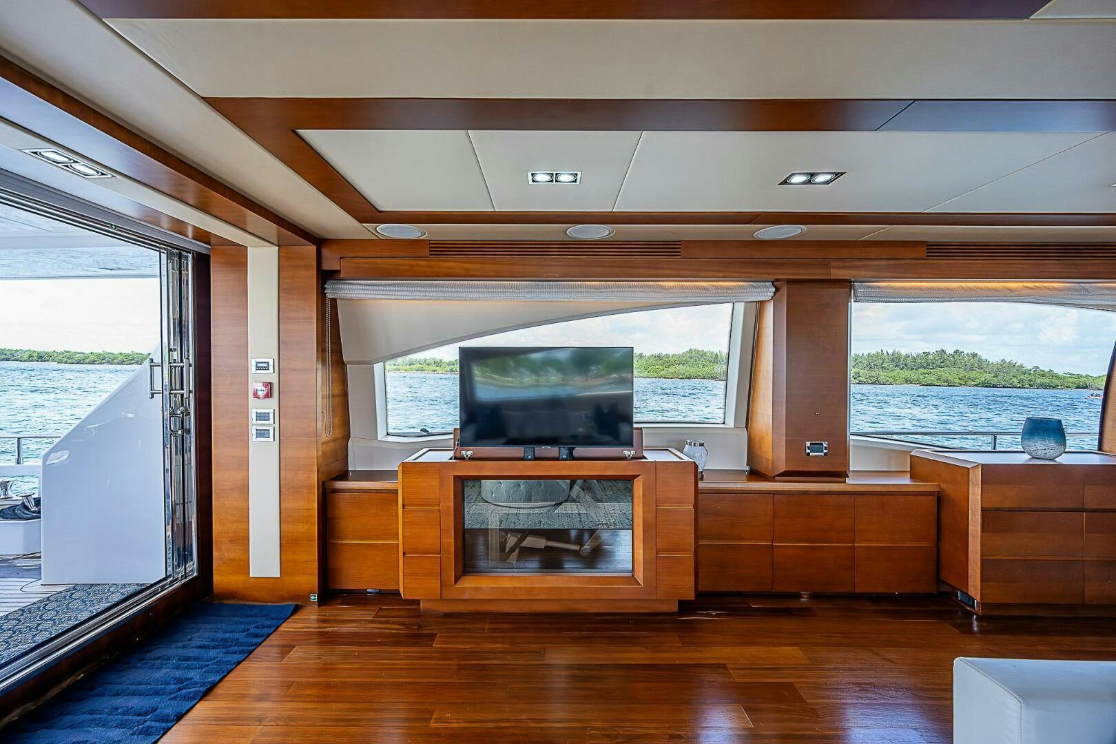 a room with a tv and a wood floor aboard LADY MARIE-CLAIRE Yacht for Sale