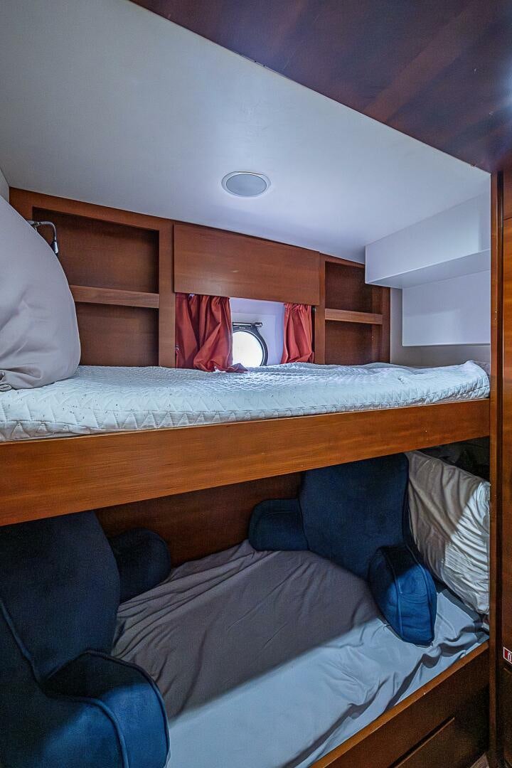 a bunk bed with a white bed and a white bed spread aboard LADY MARIE-CLAIRE Yacht for Sale