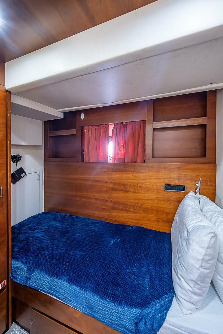 a bed with a blue sheet aboard LADY MARIE-CLAIRE Yacht for Sale
