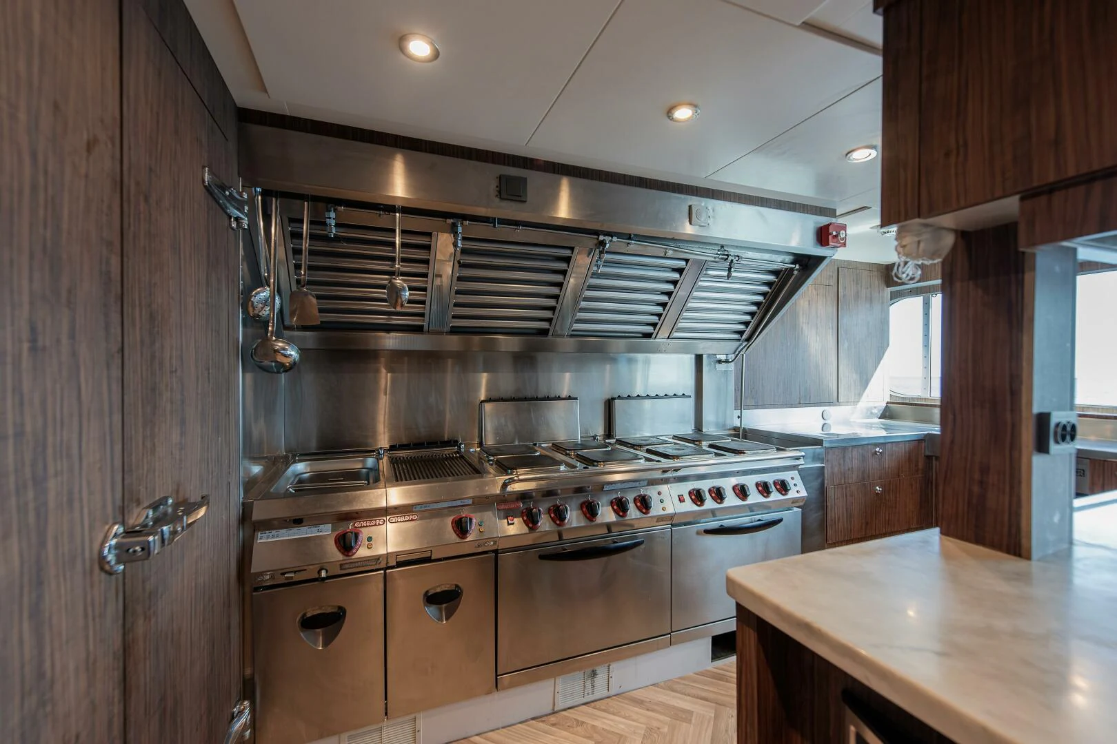 a kitchen with a stove and a sink aboard AZTECA Yacht for Sale