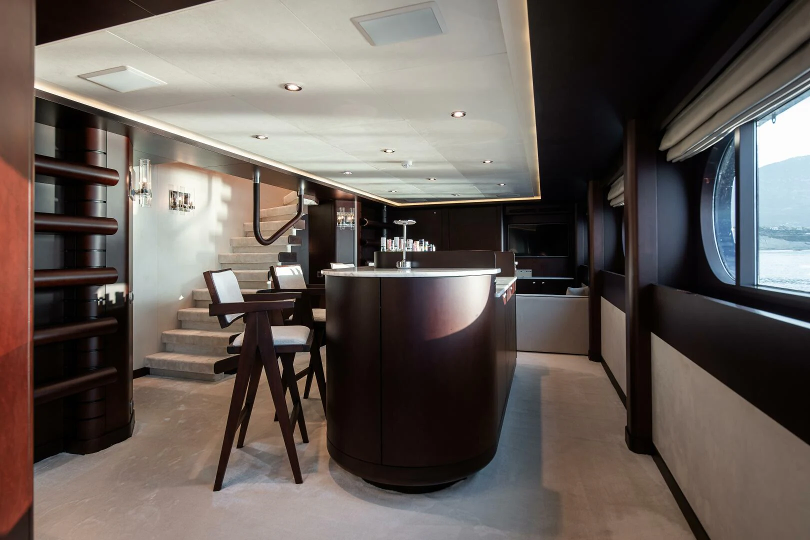 a room with a large black tub and wooden stairs aboard AZTECA Yacht for Sale