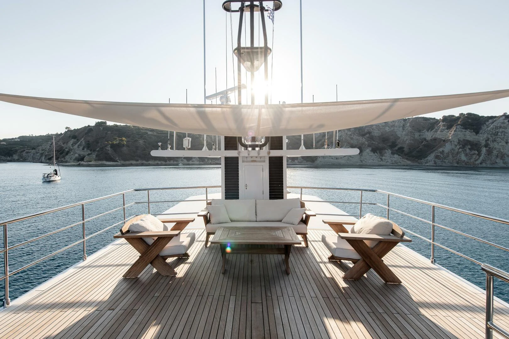 a deck with chairs on it by a body of water aboard AZTECA Yacht for Sale