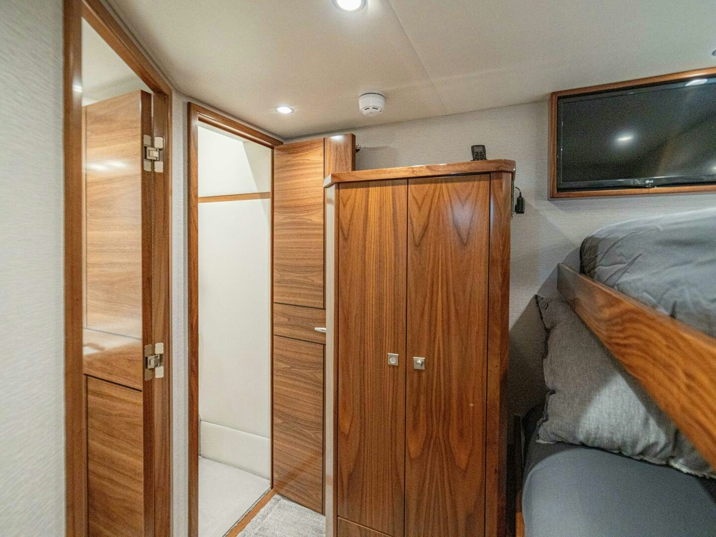 a room with a bed and a television aboard PURA VIDA Yacht for Sale