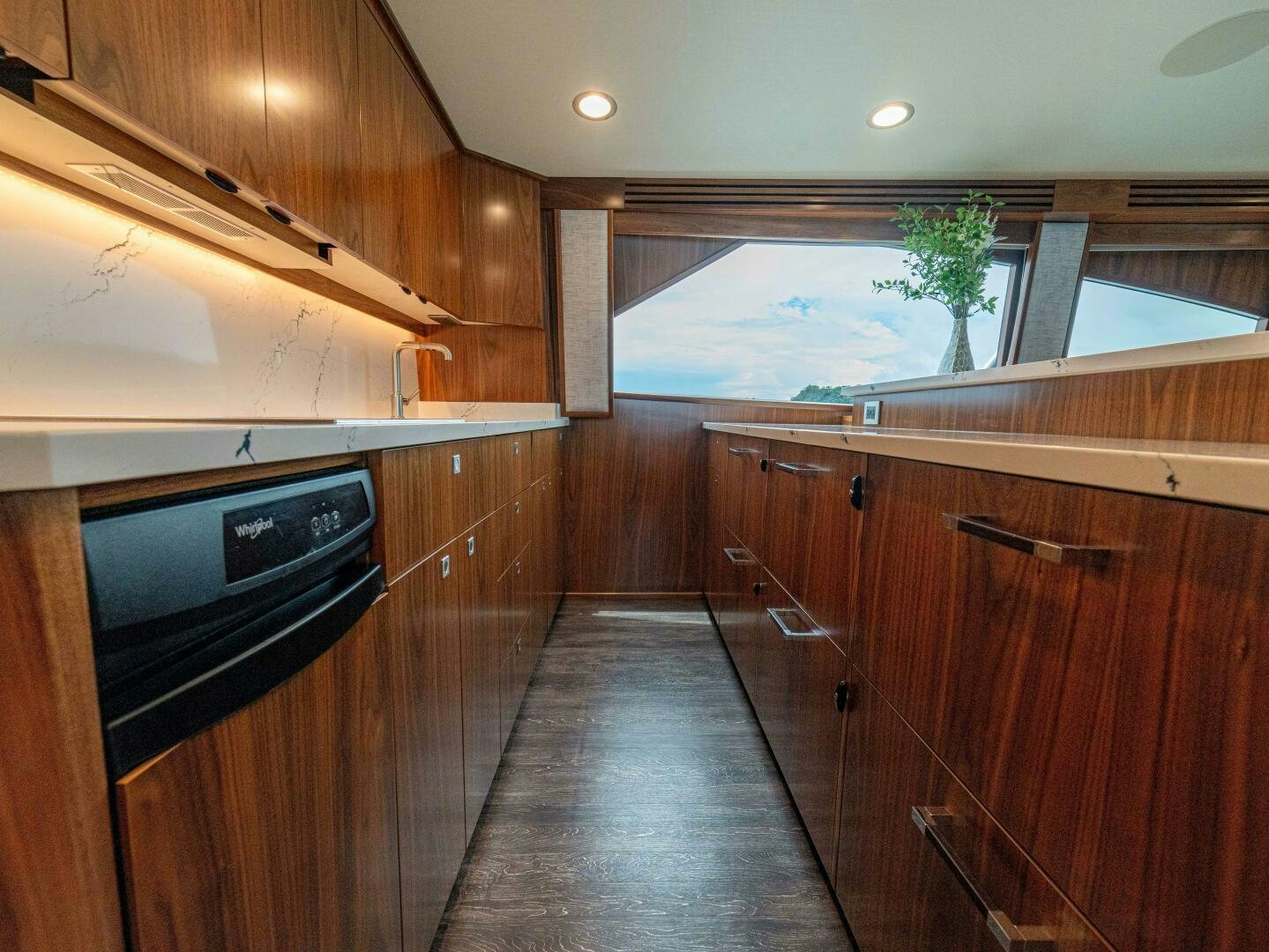 a kitchen with wooden cabinets aboard PURA VIDA Yacht for Sale