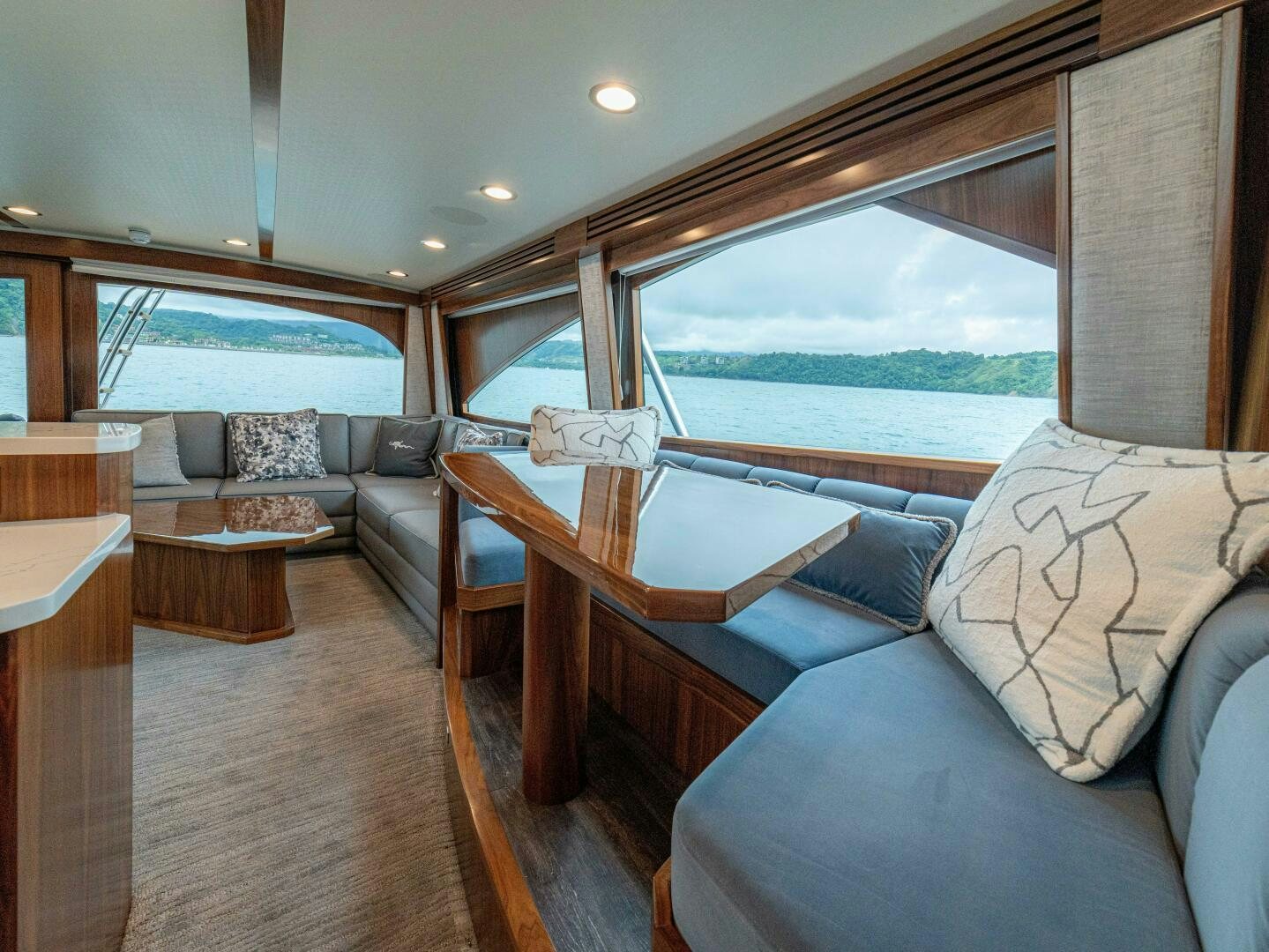 a living room with a large window aboard PURA VIDA Yacht for Sale