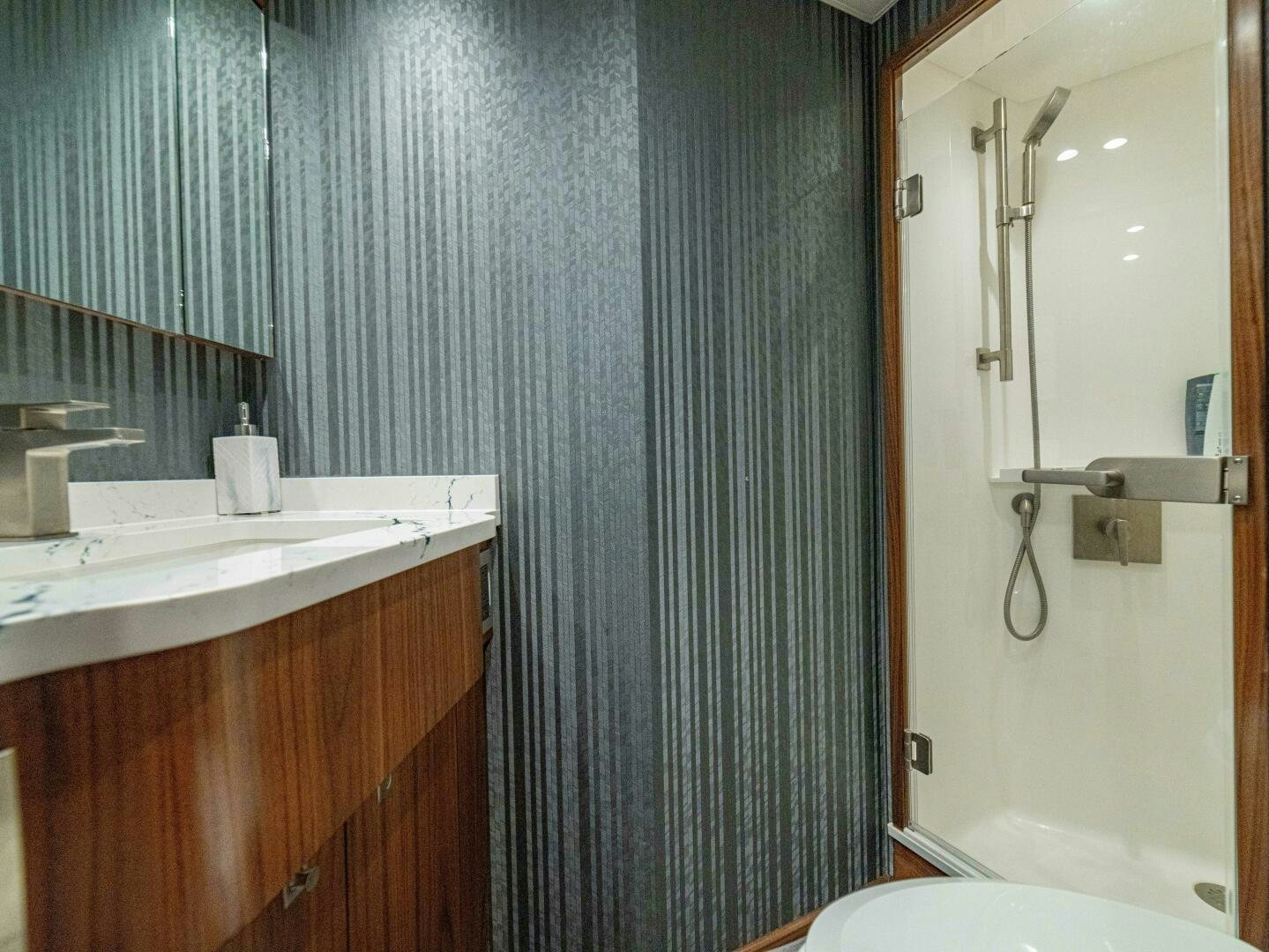 a bathroom with a shower and sink aboard PURA VIDA Yacht for Sale