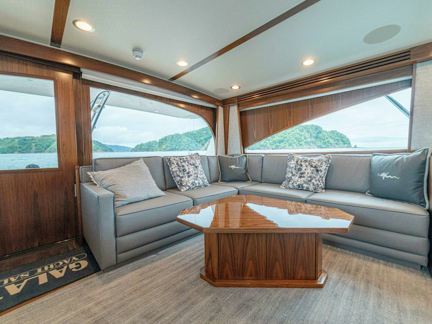 a living room with a couch and a coffee table aboard PURA VIDA Yacht for Sale