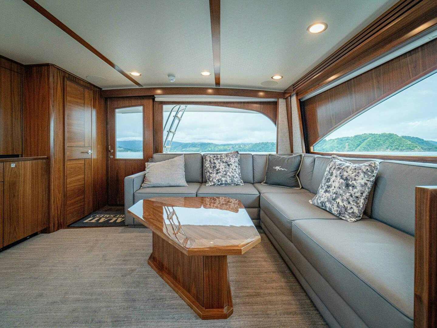 a living room with a couch and a table aboard PURA VIDA Yacht for Sale